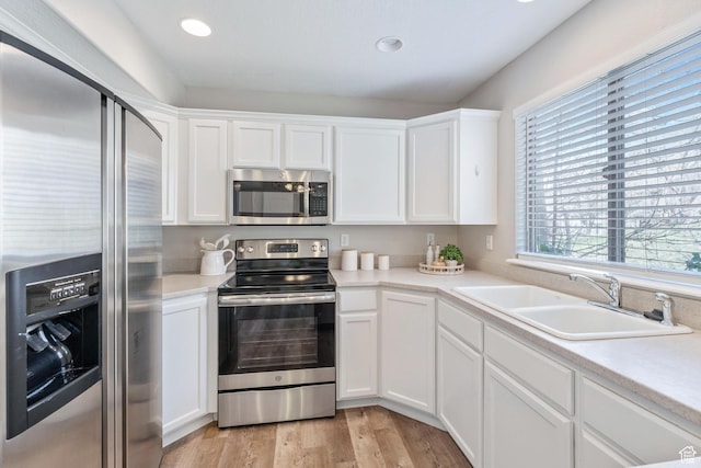 3794 W Morgan Blvd, Cedar Hills, UT 84062 - kitchen featuring stainless steel appliances, light wood-style flooring, white cabinetry, and a sink