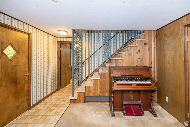 entrance foyer with wooden walls and stairway