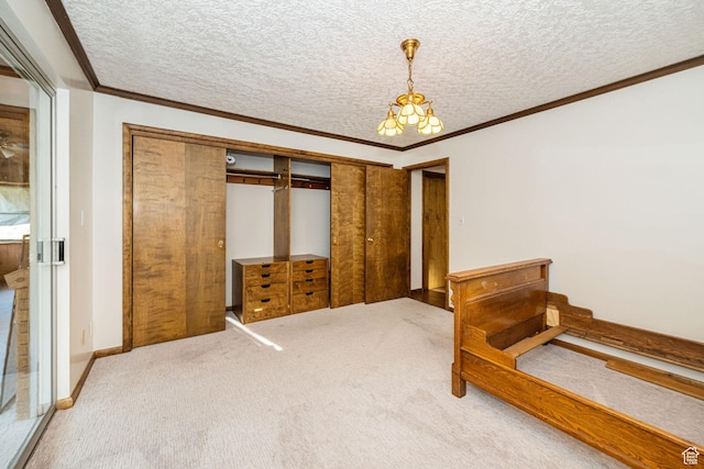 carpeted bedroom with a chandelier, crown molding, a closet, and a textured ceiling