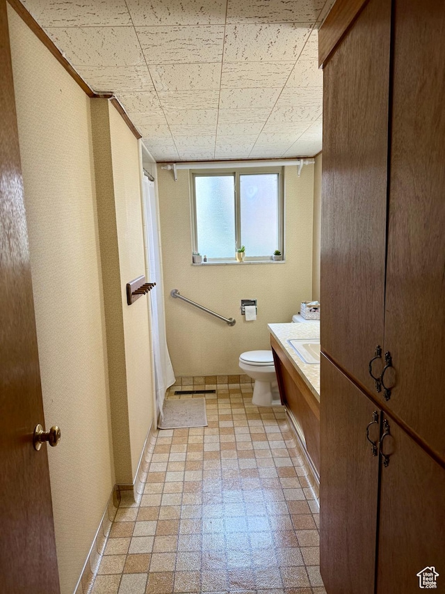 bathroom featuring toilet, tile patterned floors, vanity, and a shower with curtain