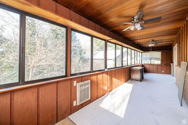 unfurnished sunroom featuring ceiling fan