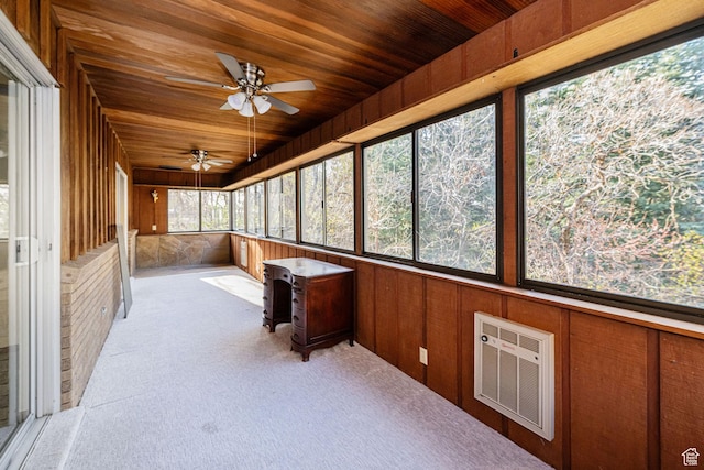 unfurnished sunroom featuring visible vents and a ceiling fan
