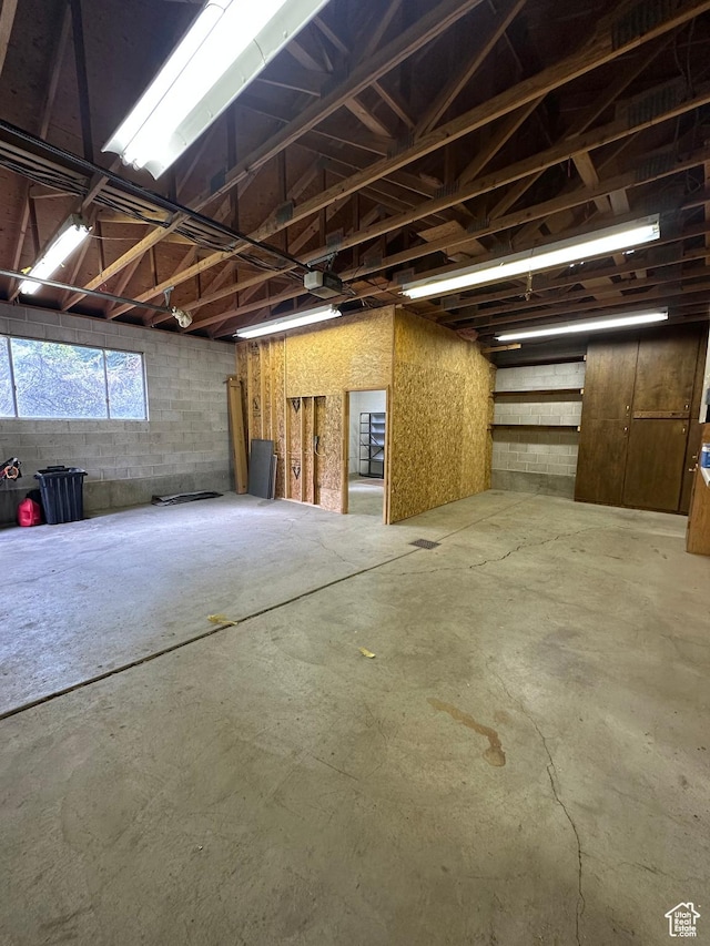 misc room with concrete flooring and a garage