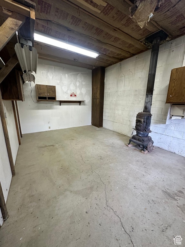 unfinished basement with a wood stove