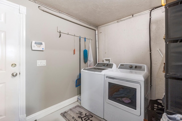 390 Ridge Dr, Heber City, UT 84032 - clothes washing area featuring washer and clothes dryer, baseboards, laundry area, and a textured ceiling