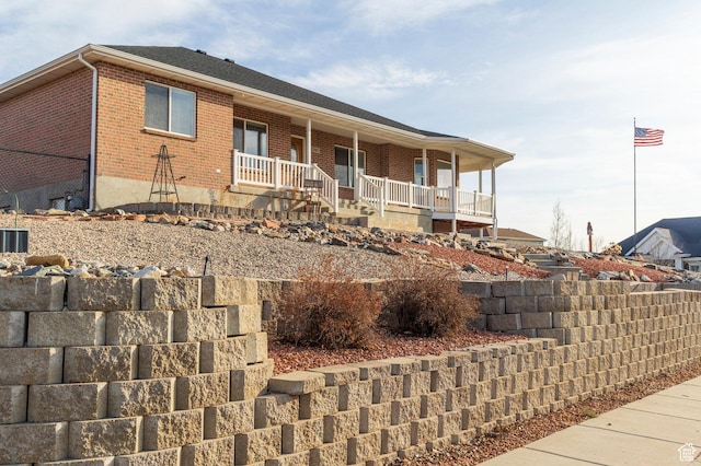 390 Ridge Dr, Heber City, UT 84032 - ranch-style house featuring covered porch and brick siding