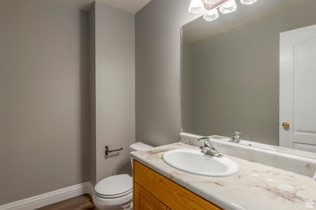 390 Ridge Dr, Heber City, UT 84032 - bathroom featuring toilet, wood finished floors, vanity, and baseboards