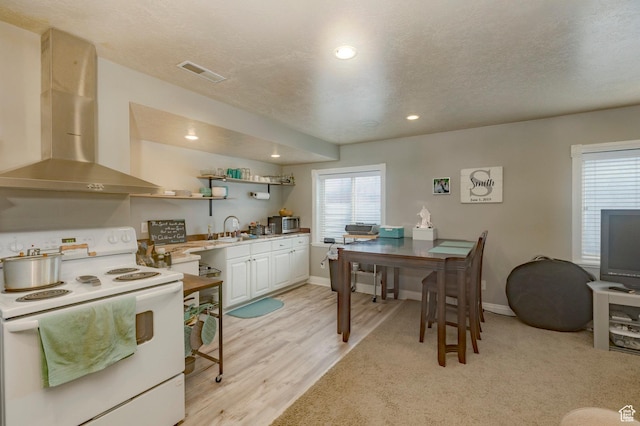 390 Ridge Dr, Heber City, UT 84032 - kitchen featuring white electric range oven, a sink, wall chimney exhaust hood, and plenty of natural light