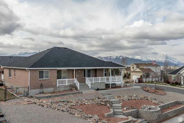 390 Ridge Dr, Heber City, UT 84032 - view of front of property with brick siding, a mountain view, a shingled roof, and covered porch