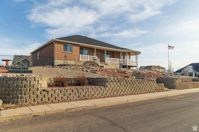 390 Ridge Dr, Heber City, UT 84032 - view of front of home with a porch, brick siding, and stairs