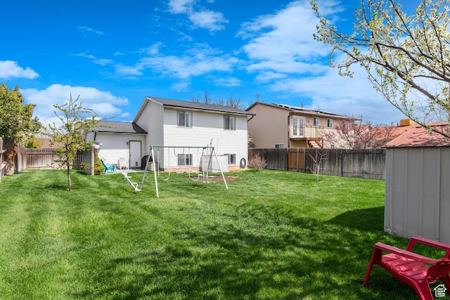 1155 W 2450 N, Layton, UT 84041 - back of house featuring a fenced backyard, an outdoor structure, and a lawn
