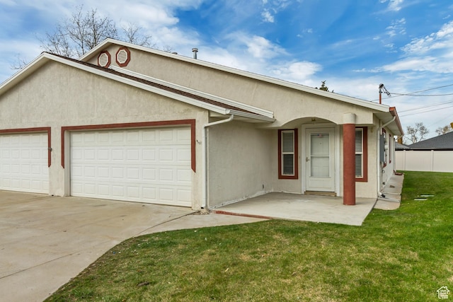 single story home featuring a garage, stucco siding, driveway, and a front yard