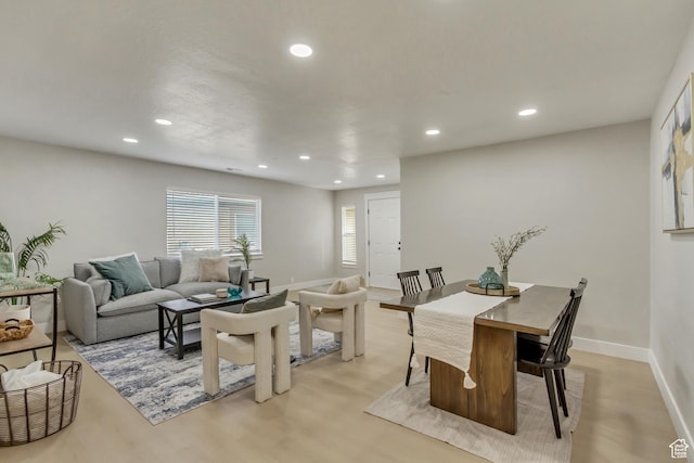 dining room featuring light wood-type flooring, baseboards, and recessed lighting