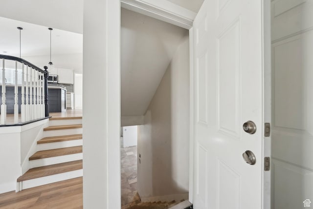 stairs featuring wood finished floors