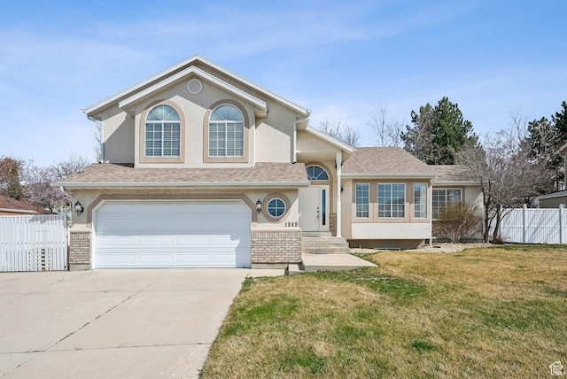 view of front of house featuring fence, a garage, driveway, and stucco siding