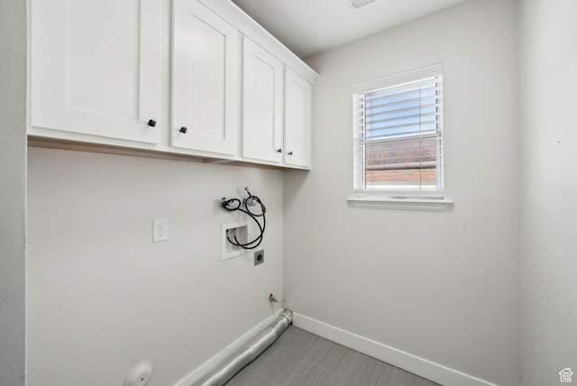 laundry area featuring hookup for a washing machine, electric dryer hookup, gas dryer hookup, baseboards, and cabinet space