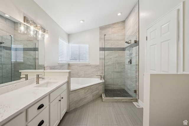 full bathroom featuring a shower stall, a bath, vanity, and lofted ceiling