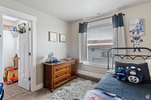 bedroom featuring light colored carpet, baseboards, and visible vents