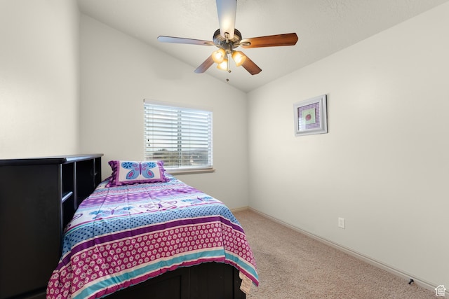 bedroom with carpet, baseboards, vaulted ceiling, and ceiling fan