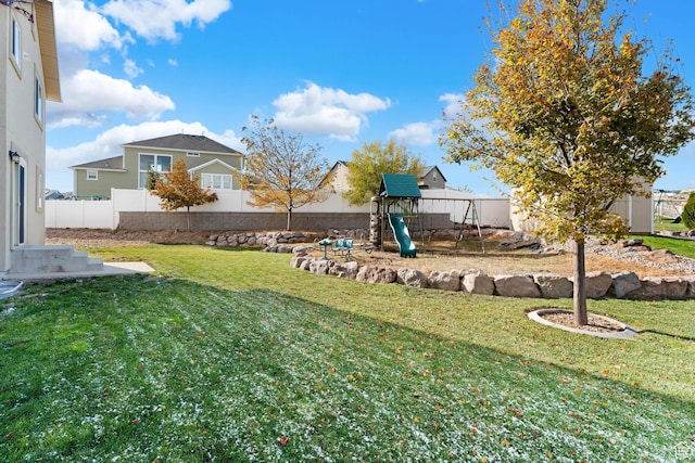 view of yard featuring a fenced backyard and a playground