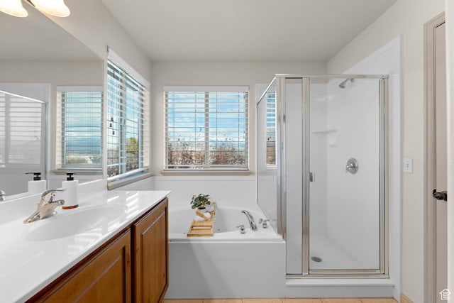 full bathroom with a bath, a stall shower, and vanity