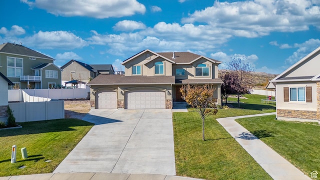 view of front facade with driveway, stucco siding, stone siding, and fence