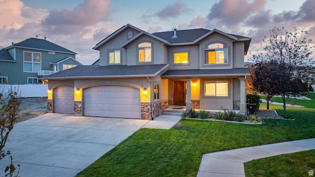 view of front facade featuring concrete driveway, stucco siding, stone siding, a front lawn, and fence