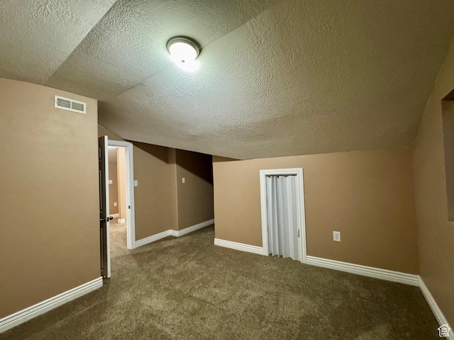 781 N Sherwood Dr, Layton, UT 84041 - additional living space with carpet, a textured ceiling, visible vents, lofted ceiling, and baseboards