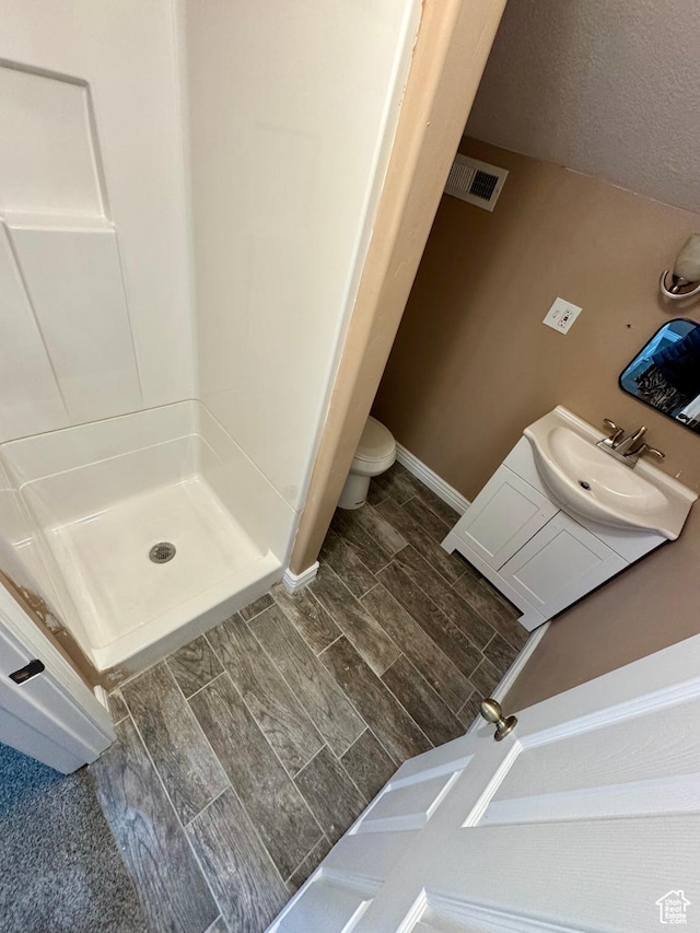 781 N Sherwood Dr, Layton, UT 84041 - bathroom with wood finish floors, toilet, a shower stall, visible vents, and a sink