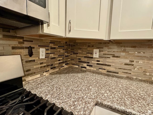 781 N Sherwood Dr, Layton, UT 84041 - room details featuring light stone countertops, range hood, white cabinetry, and decorative backsplash