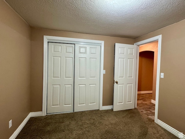 781 N Sherwood Dr, Layton, UT 84041 - unfurnished bedroom featuring baseboards, a closet, dark carpet, and a textured ceiling