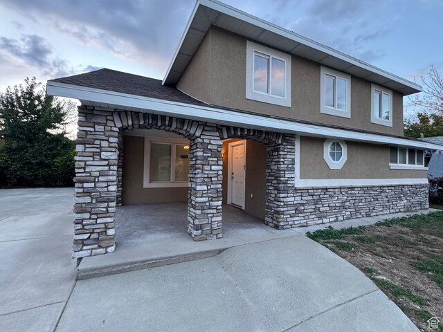 781 N Sherwood Dr, Layton, UT 84041 - view of front of home with a porch, stucco siding, and stone siding