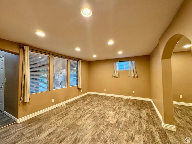 781 N Sherwood Dr, Layton, UT 84041 - unfurnished room with arched walkways, recessed lighting, baseboards, and wood finished floors