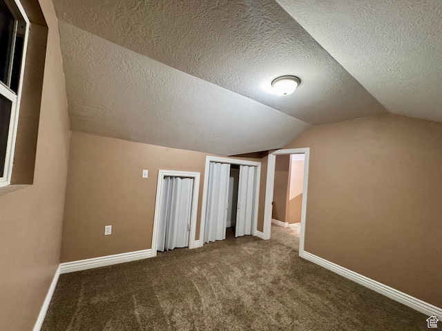 781 N Sherwood Dr, Layton, UT 84041 - additional living space with baseboards, carpet, vaulted ceiling, and a textured ceiling