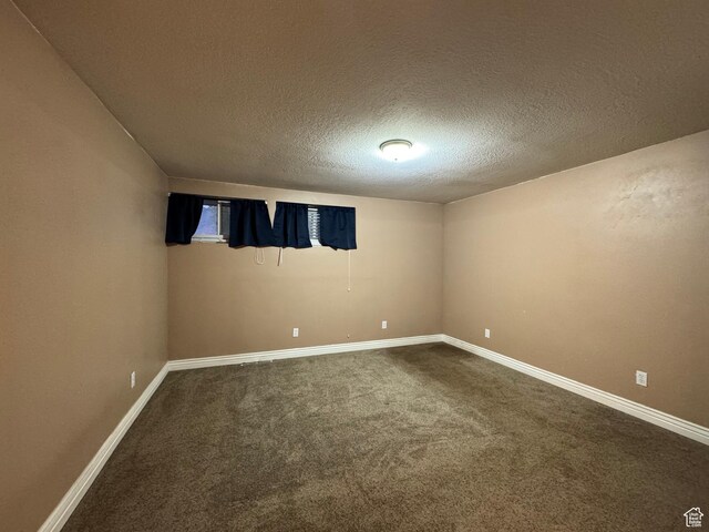 781 N Sherwood Dr, Layton, UT 84041 - unfurnished room with dark colored carpet, baseboards, and a textured ceiling