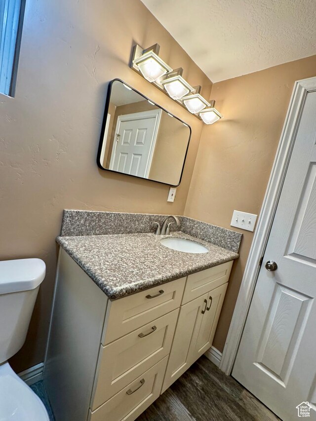 781 N Sherwood Dr, Layton, UT 84041 - bathroom with toilet, a textured ceiling, wood finished floors, and vanity