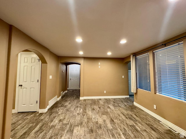 781 N Sherwood Dr, Layton, UT 84041 - empty room with arched walkways, wood finished floors, baseboards, and recessed lighting