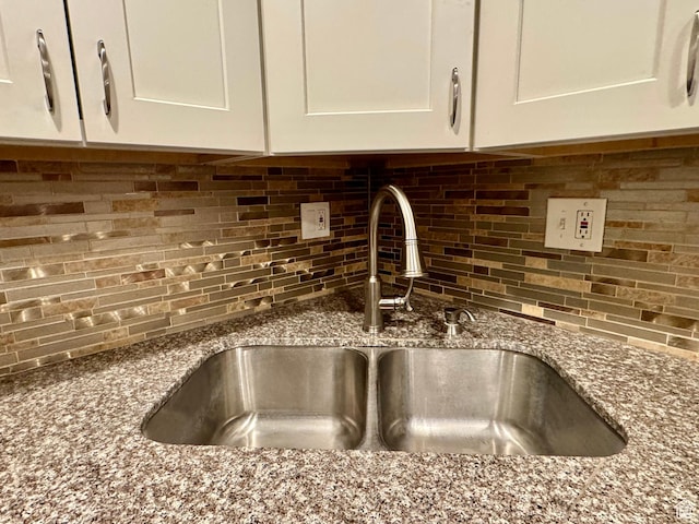 781 N Sherwood Dr, Layton, UT 84041 - details featuring a sink, stone counters, decorative backsplash, and white cabinetry