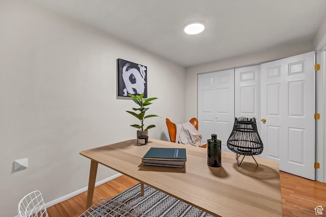 office with baseboards and light wood-style floors