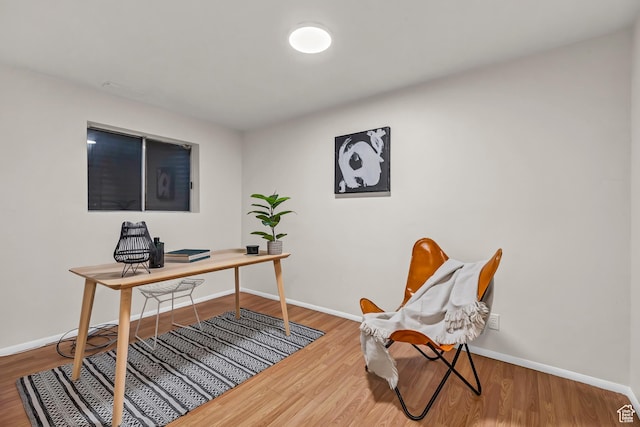 office featuring baseboards and wood finished floors
