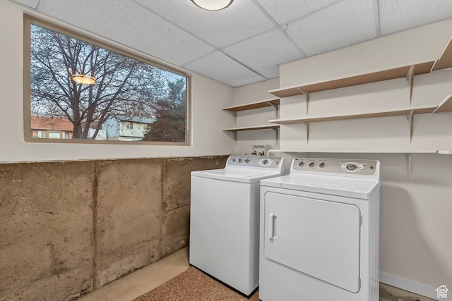 washroom with washing machine and clothes dryer and laundry area