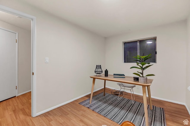 office featuring baseboards and wood finished floors