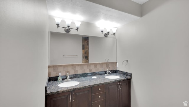 2847 W Amini Way S, Jordan, UT 84095 - bathroom featuring a chandelier, double vanity, a sink, and backsplash