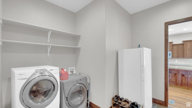 2847 W Amini Way S, Jordan, UT 84095 - laundry area with independent washer and dryer, light wood finished floors, laundry area, and baseboards