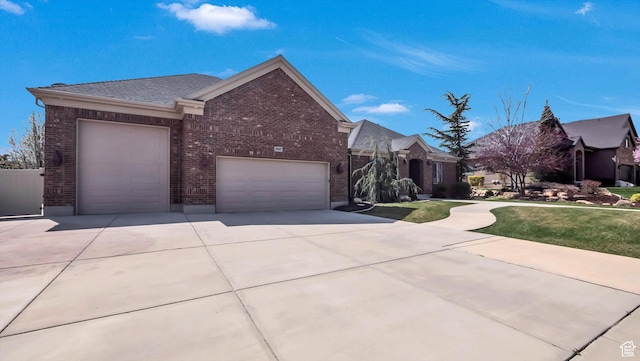 view of front of property featuring a garage, brick siding, a front lawn, and concrete driveway