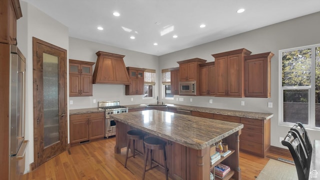 2847 W Amini Way S, Jordan, UT 84095 - kitchen featuring a center island, a sink, light wood-type flooring, stainless steel appliances, and custom range hood