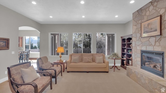 2847 W Amini Way S, Jordan, UT 84095 - living area with baseboards, recessed lighting, arched walkways, and a fireplace