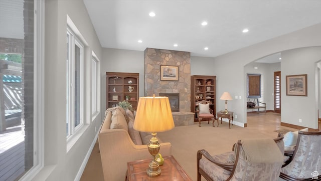 2847 W Amini Way S, Jordan, UT 84095 - living area featuring carpet, arched walkways, a stone fireplace, recessed lighting, and baseboards
