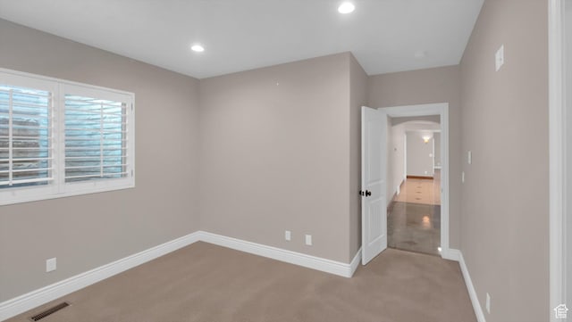 2847 W Amini Way S, Jordan, UT 84095 - unfurnished bedroom with arched walkways, visible vents, recessed lighting, light carpet, and baseboards