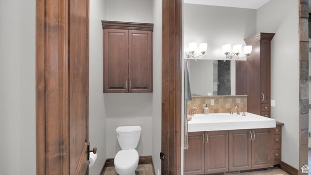2847 W Amini Way S, Jordan, UT 84095 - bathroom with toilet, vanity, baseboards, and backsplash